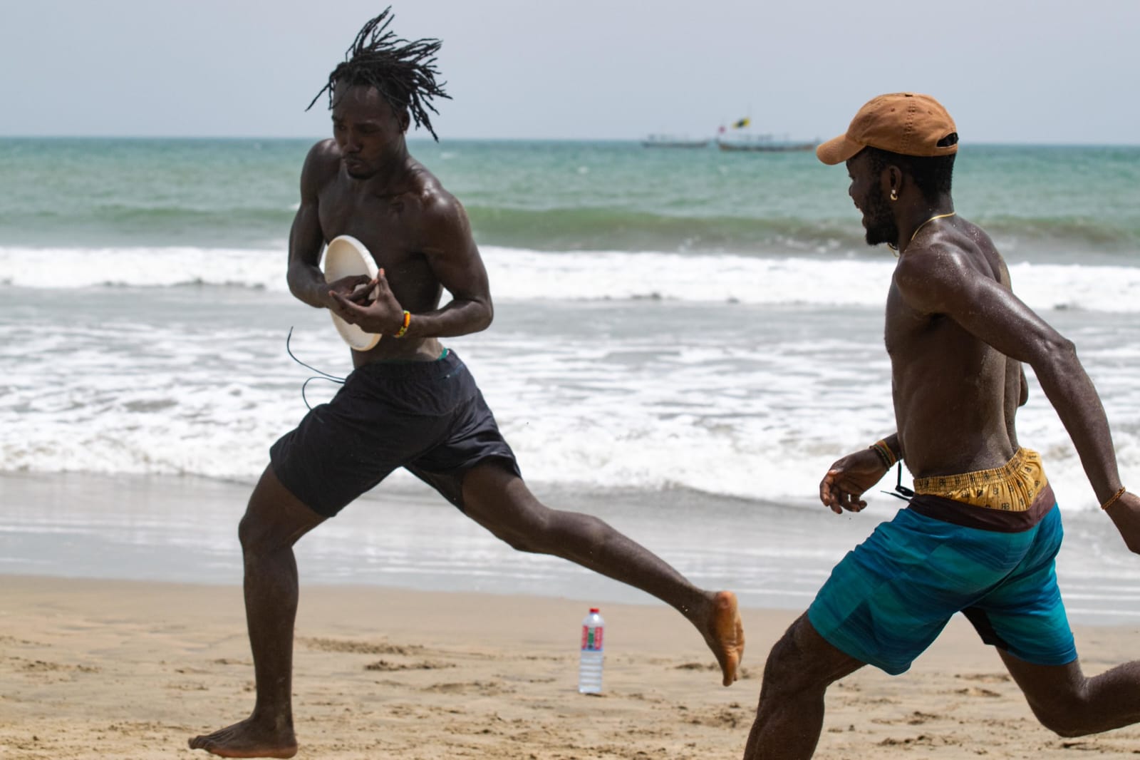 Brothers playing frisbee on Kokrobite beach
